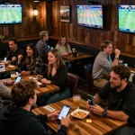 cm88 engaging patrons placing bets in a lively sports bar with multiple screens displaying events