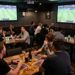 Fans actively placing bets and celebrating victories at the sports bar, keonhacai captured in the thrilling atmosphere.